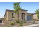 Single-story home featuring stone accents, a two-car garage, and low-maintenance landscaping at 58 Sun Lily Ln, Henderson, NV 89011