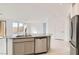 Modern kitchen features granite counters, stainless steel appliances, and large windows for natural light at 58 Sun Lily Ln, Henderson, NV 89011