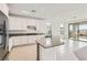 Stylish kitchen with granite island, stainless appliances, and backyard views at 58 Sun Lily Ln, Henderson, NV 89011
