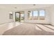 Bright living room with large windows and sliding glass door to the backyard at 58 Sun Lily Ln, Henderson, NV 89011