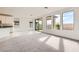 Sun-filled living room open to kitchen, features backyard access and views at 58 Sun Lily Ln, Henderson, NV 89011