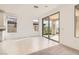 Living room with tile floor and sliding doors to backyard patio at 58 Sun Lily Ln, Henderson, NV 89011