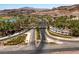 Lake Las Vegas entrance with palm trees, desert landscaping, and a view of the mountains beyond the community at 58 Sun Lily Ln, Henderson, NV 89011