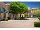 A quaint town center with landscaped walkways, boutique storefronts, and lush green trees at 58 Sun Lily Ln, Henderson, NV 89011