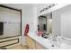 Bright bathroom featuring double sinks, updated fixtures, and shower with glass door at 5950 Pacific Shores Dr, Las Vegas, NV 89142