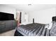 Bedroom with tufted round bed, dresser, and view into the Primary bath at 5950 Pacific Shores Dr, Las Vegas, NV 89142