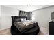 A bedroom features carpet floors, neutral walls, and a circular bed with tufted accents at 5950 Pacific Shores Dr, Las Vegas, NV 89142