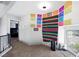 A bedroom features carpet floors, a window nook, and colorful decorations at 5950 Pacific Shores Dr, Las Vegas, NV 89142