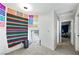A bedroom features carpet floors, a window nook, and colorful decorations at 5950 Pacific Shores Dr, Las Vegas, NV 89142