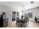 A dining room features modern chandelier lighting, tile floors, and sliding door at 5950 Pacific Shores Dr, Las Vegas, NV 89142