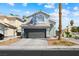 Charming two-story home featuring a gray garage door, a well-manicured lawn and blue sky background at 5950 Pacific Shores Dr, Las Vegas, NV 89142
