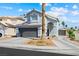 Charming two-story home featuring a gray garage door, a well-manicured lawn and blue sky background at 5950 Pacific Shores Dr, Las Vegas, NV 89142