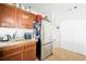 Kitchen features stainless steel refrigerator and wooden cabinets with granite countertops at 5950 Pacific Shores Dr, Las Vegas, NV 89142