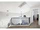 An upstairs landing features carpet floors, a ceiling fan, and natural light at 5950 Pacific Shores Dr, Las Vegas, NV 89142