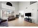 Cozy living room featuring high ceilings, tile flooring, a fireplace and backyard access at 5950 Pacific Shores Dr, Las Vegas, NV 89142