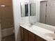 Bathroom featuring double sinks and vanity with a shower in the background at 6416 Pronghorn Ridge Ave, Las Vegas, NV 89122