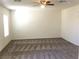 A large bonus room with carpet flooring and ample natural light at 6416 Pronghorn Ridge Ave, Las Vegas, NV 89122