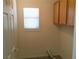 This laundry area features overhead cabinets and a window at 6416 Pronghorn Ridge Ave, Las Vegas, NV 89122