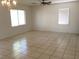 Spacious living room with tile floors, natural light and classic chandelier at 6416 Pronghorn Ridge Ave, Las Vegas, NV 89122
