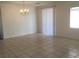 Bright living room with tile floors, natural light and a classic chandelier at 6416 Pronghorn Ridge Ave, Las Vegas, NV 89122