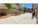 Large backyard with a well-kept concrete patio and raised brick planter; ample space for outdoor activities at 6429 Rosemount Ave, Las Vegas, NV 89156