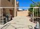 Spacious concrete backyard patio with brick border, metal canopy, a grill and block wall for privacy at 6429 Rosemount Ave, Las Vegas, NV 89156