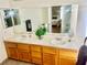 Bathroom featuring double sink vanity, spacious mirrors, and bright natural light at 6429 Rosemount Ave, Las Vegas, NV 89156