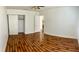 Bright bedroom featuring hard wood flooring, white walls, and sliding closet at 6429 Rosemount Ave, Las Vegas, NV 89156