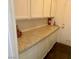 Functional laundry area offers ample storage with white cabinets and a speckled countertop for folding at 6429 Rosemount Ave, Las Vegas, NV 89156