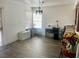 Bright dining room with wood-look tile floors, chandelier, and natural light from the window at 6429 Rosemount Ave, Las Vegas, NV 89156