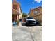 Long driveway with a white RAM truck parked in front of two tan homes, offering ample parking space at 6429 Rosemount Ave, Las Vegas, NV 89156