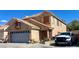 Charming two-story home with a well-maintained front yard and a visible two-car garage, and white truck at 6429 Rosemount Ave, Las Vegas, NV 89156