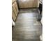 Close up of gray wood-style flooring in kitchen area with tan cabinets in background at 6429 Rosemount Ave, Las Vegas, NV 89156
