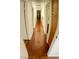 Hallway boasts hardwood floors and neutral paint, creating a warm and inviting transition between rooms at 6429 Rosemount Ave, Las Vegas, NV 89156