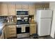 Traditional kitchen featuring wooden cabinets, granite countertops, and stainless steel appliances at 6429 Rosemount Ave, Las Vegas, NV 89156