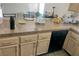 This Kitchen includes granite countertops, a sink, and a black dishwasher at 6429 Rosemount Ave, Las Vegas, NV 89156