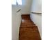Staircase features wood steps, white risers, and a handrail, providing a stylish transition between floors at 6429 Rosemount Ave, Las Vegas, NV 89156