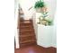 Charming staircase enhanced with potted plants, creating a warm, inviting ascent to the next level of the home at 6429 Rosemount Ave, Las Vegas, NV 89156