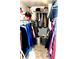 Walk-in closet, showing clothes hanging on the rods and the floor space at 6429 Rosemount Ave, Las Vegas, NV 89156