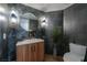 Stylish bathroom featuring a wood vanity, a round mirror, and decorative tiles at 7625 Spanish Bay Dr, Las Vegas, NV 89113