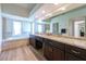 Bright bathroom features a soaking tub, separate shower, dual sinks with granite counters, and ample natural light at 7625 Spanish Bay Dr, Las Vegas, NV 89113