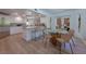 Well-lit kitchen with white cabinets, a granite countertop island, and a breakfast nook at 7625 Spanish Bay Dr, Las Vegas, NV 89113