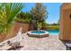 Backyard pool and hot tub featuring lush palms and a hammock to create a backyard oasis at 7625 Spanish Bay Dr, Las Vegas, NV 89113