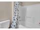 Clean bathroom showcases a shower-tub combination with a white seashell shower curtain at 8250 N Grand Canyon Dr # 1123, Las Vegas, NV 89166