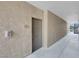 Close-up of a condo doorway with number 1123, with stucco walls and fire equipment at 8250 N Grand Canyon Dr # 1123, Las Vegas, NV 89166