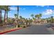 Gated community entrance with lush landscaping and well-maintained roadways at 8250 N Grand Canyon Dr # 1123, Las Vegas, NV 89166