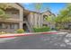 Condominium complex featuring multiple units, balconies, and inviting landscaping with trees and green shrubs at 8250 N Grand Canyon Dr # 1123, Las Vegas, NV 89166