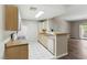 Well-equipped kitchen featuring updated appliances, tile floors, and access to the balcony at 8250 N Grand Canyon Dr # 1123, Las Vegas, NV 89166