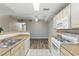 Well lit kitchen featuring white cabinets, white appliances, and dining area at 8250 N Grand Canyon Dr # 1123, Las Vegas, NV 89166