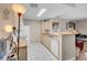 Bright kitchen with white appliances, tile flooring, and a breakfast bar overlooking the living area at 8250 N Grand Canyon Dr # 1123, Las Vegas, NV 89166